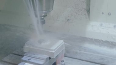 Fabrikada metal işçiliği kesen soğutma sistemi olan bir değirmen makinesi.