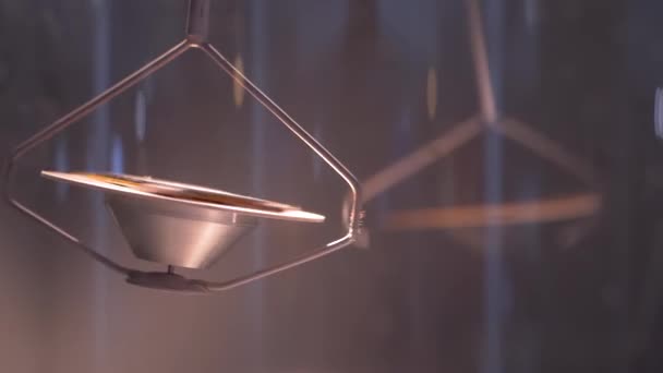Slow motion: hanging metal gyroscope spinning top pendulum - close up — Stock Video