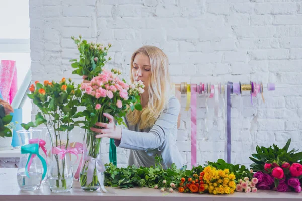 Portrait of professional floral artist working with flowers at studio