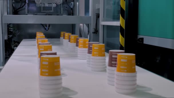 Empty plastic cups moving on conveyor belt at exhibition — Stock Video
