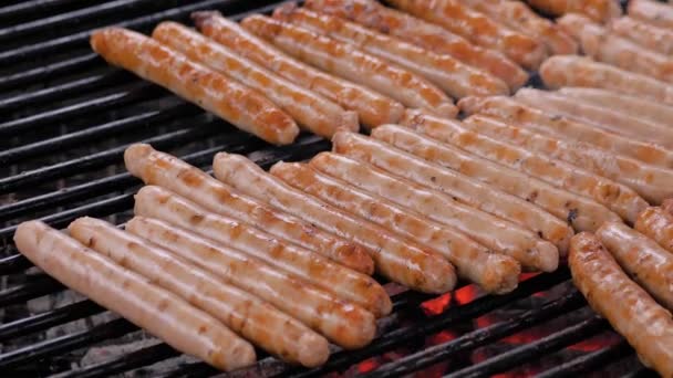 Séf grillezés friss hús kolbászok nagy kerek lógó grill - közelről — Stock videók