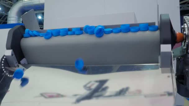 许多蓝色塑料瓶盖从输送带上掉下来-生产线 — 图库视频影像