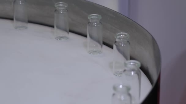 Linha de produção farmacêutica - correia transportadora com frascos de vidro de injeção vazios — Vídeo de Stock