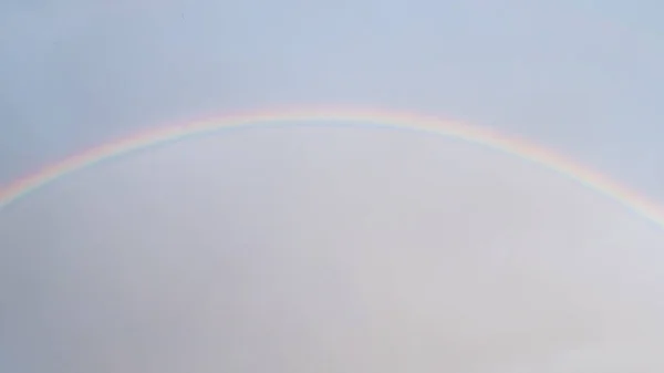 Rainbow in grey sky - nature concept