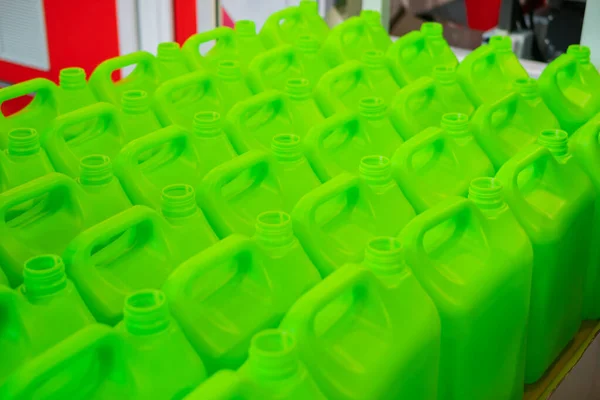 Many empty green plastic jerrycans