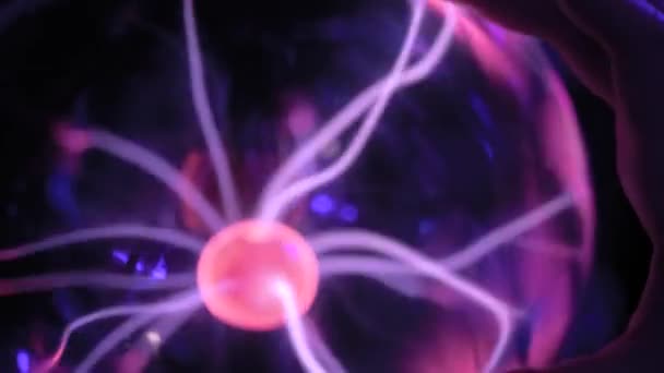 Woman hand touching plasma ball with many energy rays inside - close up — Stock Video