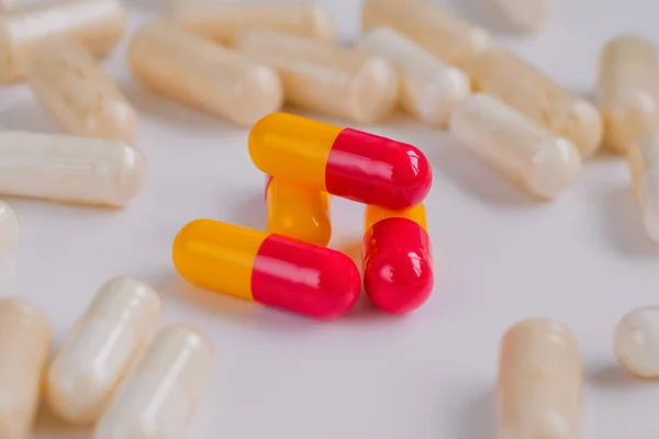 Pills, tablets, drugs, meds, medications on white surface - close up