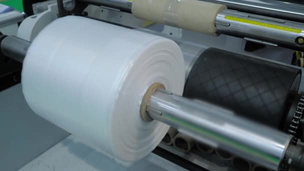 Automatic plastic bag making machine - roller with polyethylene film - close up — Stock Video