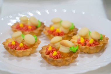 Taze, kremalı tart kekleri ve satılık tatlı mantarlar.