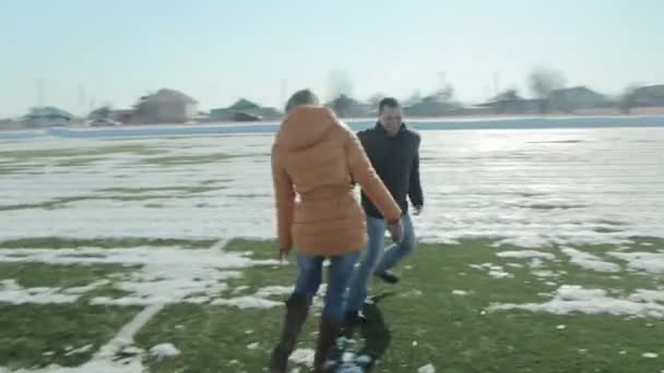 Pareja jugando y corriendo en el campo de fútbol — Vídeos de Stock