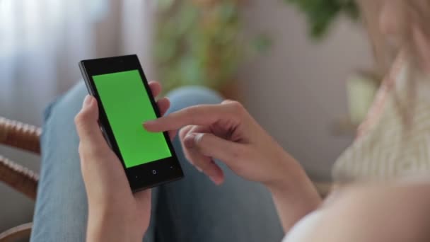 Woman hands touching, scrolling, zoom in, zoom out smartphone.green screen display — Stock Video