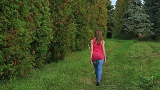 Chica caminando a través de callejón verde — Vídeos de Stock