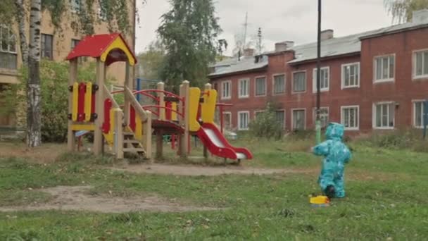 Toddler boy walking in the park with toy car — Stock Video