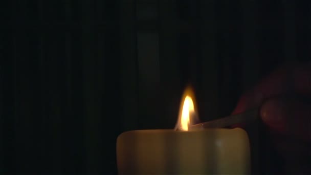 Lighting a candle with match in slow motion. Close Up — Stock Video
