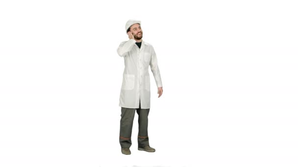 Male engineer talking on the phone while supervising construction on white background. — Stock Video
