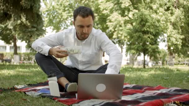 Podnikatelé mají pauzu na louky s notebookem. — Stock video