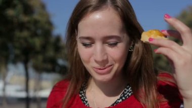 Young beautiful female eating tapas at street