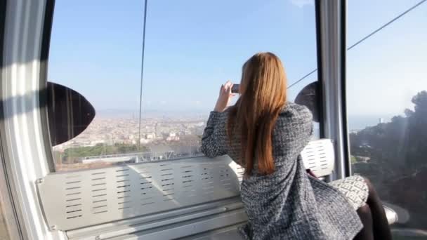 Woman in funicular make photo of city view — Stockvideo