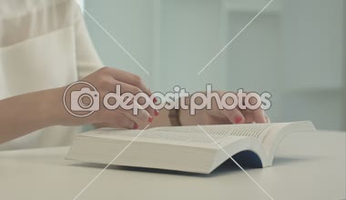 Tablo ve kitap okumak oturan kadın