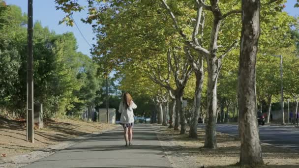 Girl walking throught cork tree alley street portugal — Stock Video