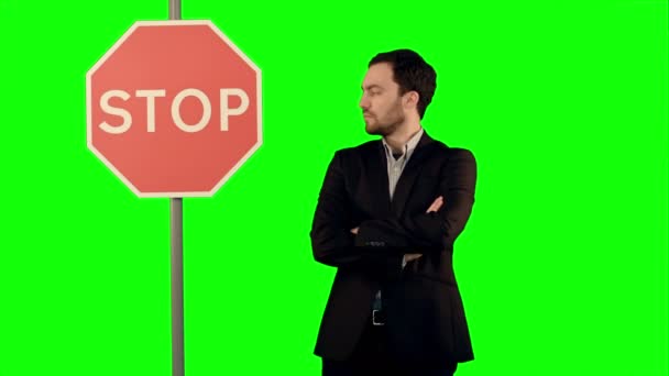 Businessman standing near a stop sign on laptop on a Green Screen, Chroma Key. — Stock Video