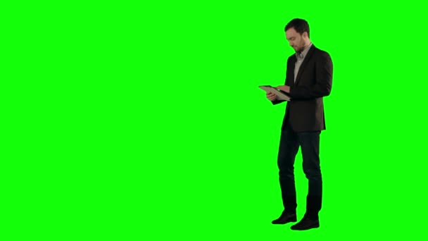 Glücklicher junger Mann mit digitalem Tablet auf grünem Bildschirm — Stockvideo