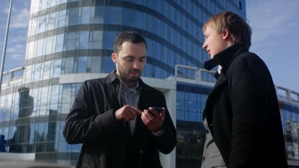 Two young business man looking offer at their smartphone — Stock Video