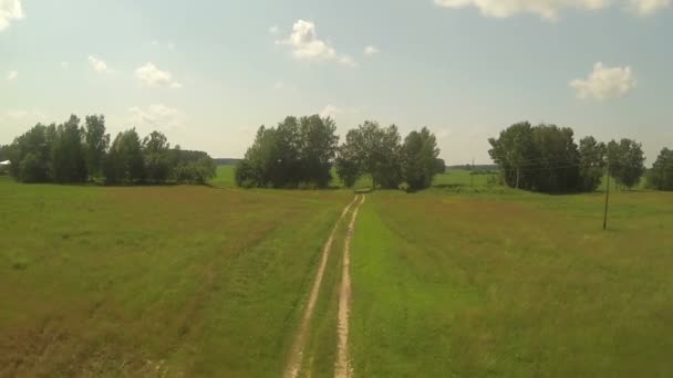 Vista aérea da estrada no campo vermelho verde, dia ensolarado no lado do país, rissia, byroad — Vídeo de Stock