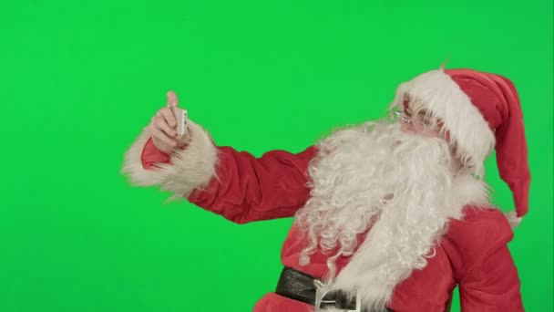 Santa Claus, hogy selfie, gazdaság egy nagy jelen egy zöld képernyő Chrome kulcs