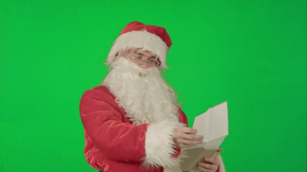 Santa Claus čtení dopisů od dětí na zelené obrazovce Chrome klíč