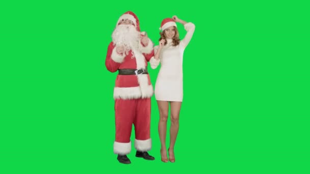 Santa Claus izgatott pinup táncoló nő egy zöld képernyő Chrome kulcs