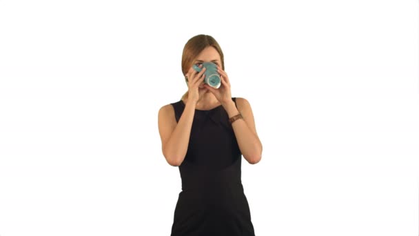 Joven hermosa mujer sosteniendo la taza de té o café sobre fondo blanco aislado — Vídeos de Stock