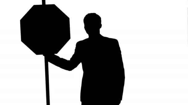 Silhouette A businessman holding a stop sign on laptop. — Stock Video