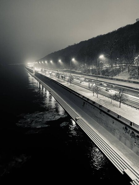 Night traffic by the right bank of Dnipro river, Kyiv, Ukraine