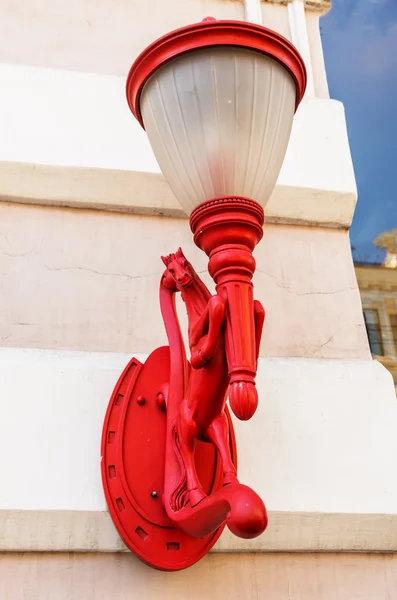 Red lamp with horse on the street wall — Stock Photo, Image