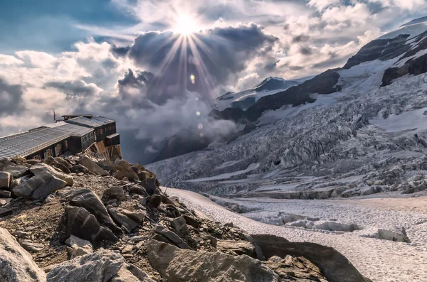Hermosa puesta de sol en el glaciar con alp rifugio —  Fotos de Stock