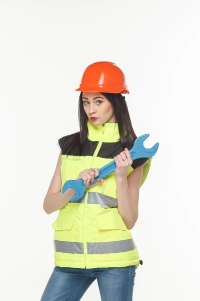 Menina em um colete amarelo com a ferramenta — Fotografia de Stock