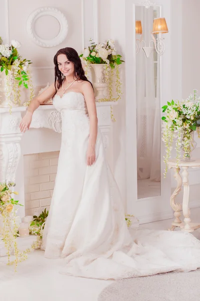 Wedding dress in Paris. luxury apartment a dress. Bride near the window and fireplace — Stock Photo, Image