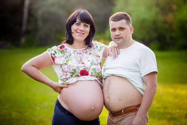 Pregnant naked belly touches men — Stock Photo, Image