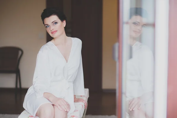 Woman wearing bathrobe at hotel room — Stock Photo, Image