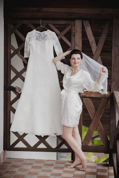 Beautiful bride at wedding dress walking outdoors — Stock Photo, Image