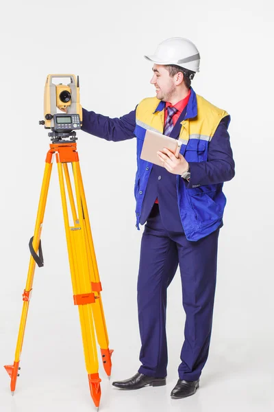 Worker looking into the level — Stock Photo, Image