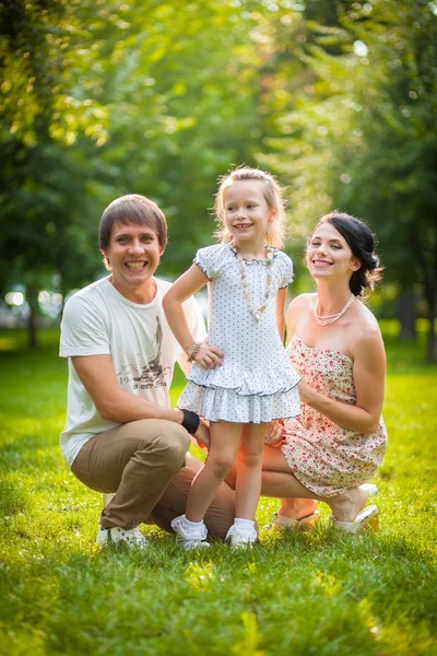 Young family playing with a baby in the park — Stock Photo, Image