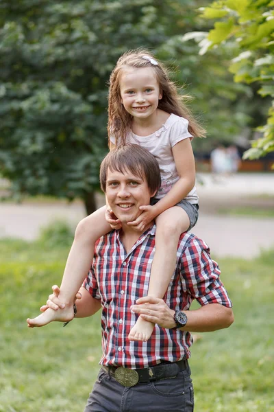 Daughter on the neck of dads — Stock Photo, Image