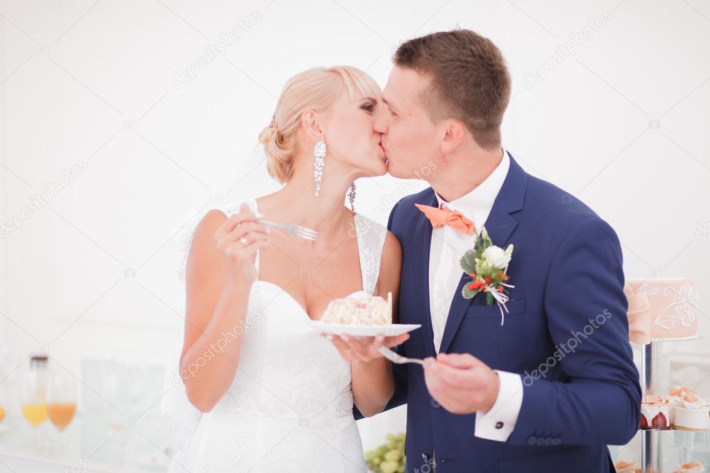 the bride and groom eat the cake