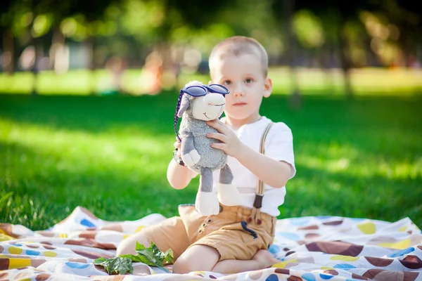 Boy on the blanket in the park — Stock Photo, Image