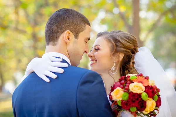 Gentle hugs and kisses the bride groom