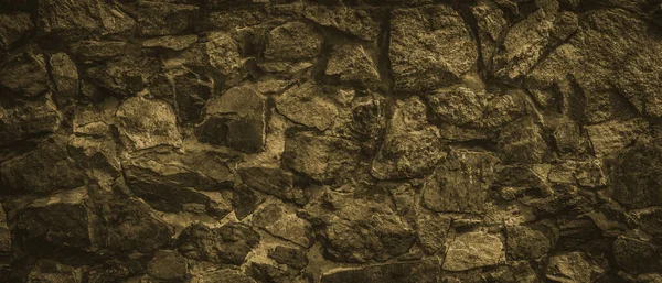 Dark brown stone wall texture background.