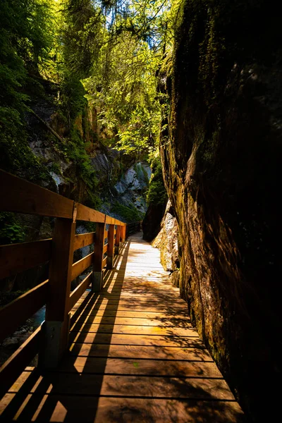 Beautiful wooden path trail for nature trekking and alp hiking with mountain river, canyon and waterfall, located in Wimbachklamm, Berchtesgaden, Bavaria, Germany (Bavarian Alps)