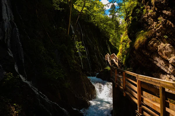 Beautiful wooden path trail for nature trekking and alp hiking with mountain river, canyon and waterfall, located in Wimbachklamm, Berchtesgaden, Bavaria, Germany (Bavarian Alps)